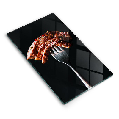 Chopping board glass Meat on a fork
