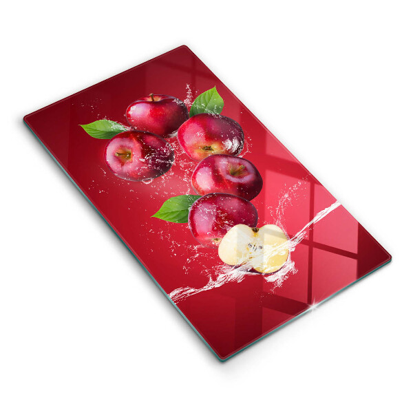 Chopping board glass Juicy apples in the water