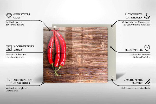 Chopping board glass Chili peppers on wood