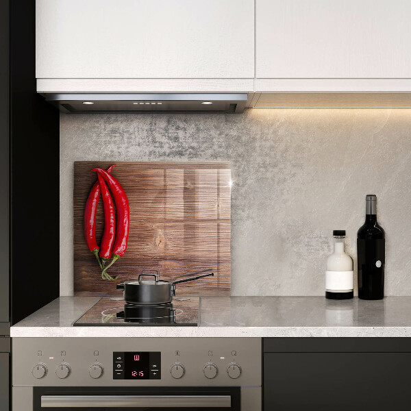 Chopping board glass Chili peppers on wood