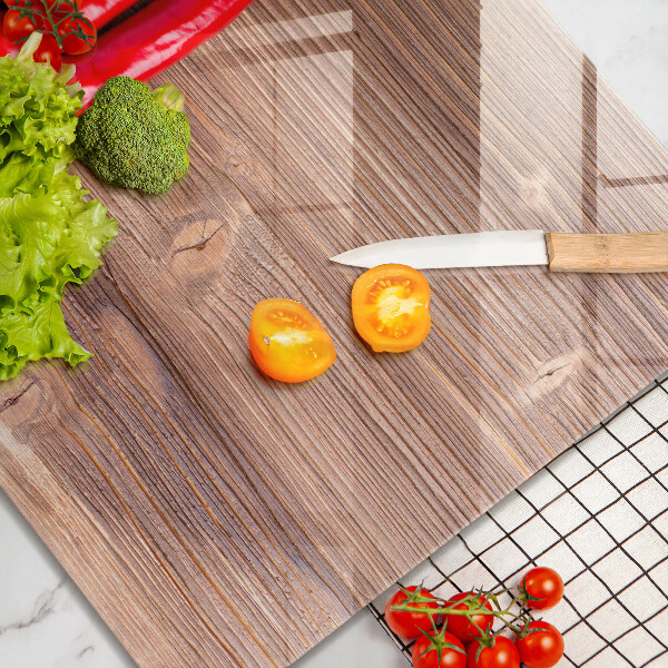 Chopping board glass Chili peppers on wood