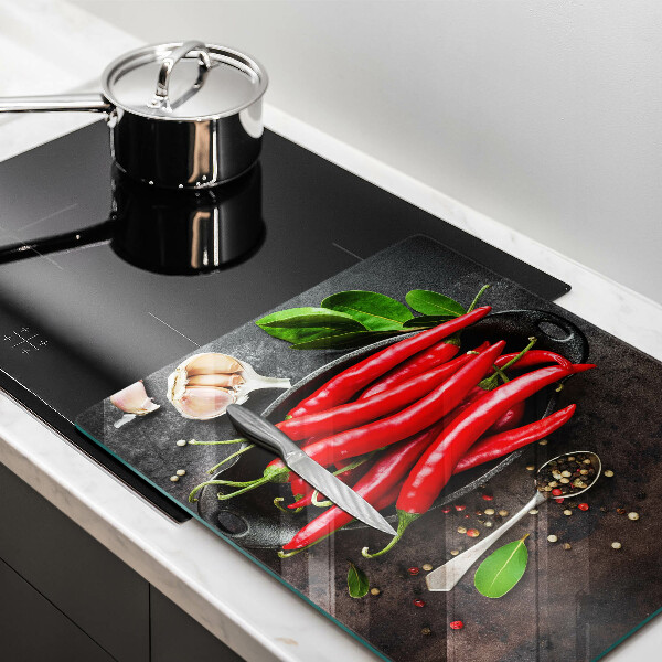 Chopping board glass Red chili peppers