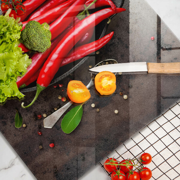 Chopping board glass Red chili peppers