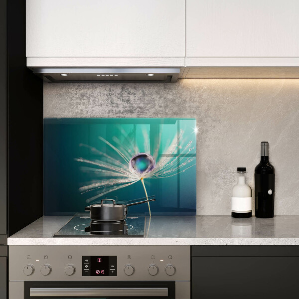 Chopping board glass Dew on a dandelion