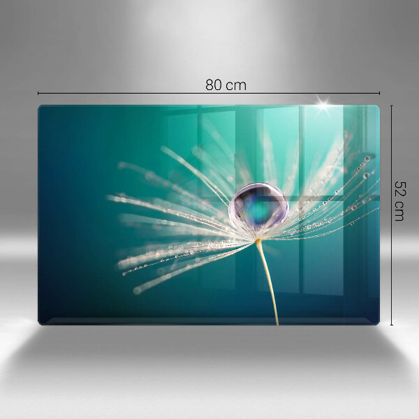 Chopping board glass Dew on a dandelion