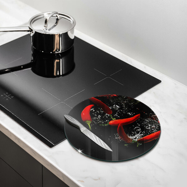 Chopping board glass Chili peppers in water