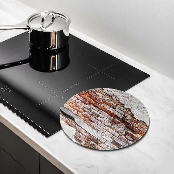 Chopping board glass Old wall of brick and concrete