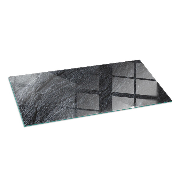 Rectangular glass hearth for log burner Stone surface texture
