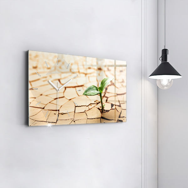 Horizontal wall clock A plant in dried-out soil