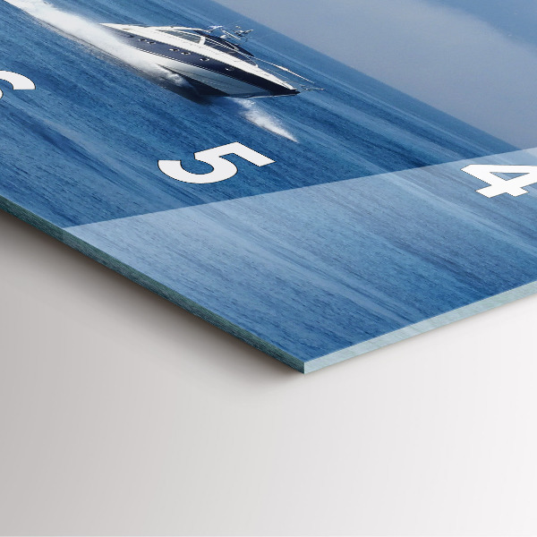 Square wall clock A boat floating on the ocean