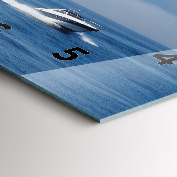 Square wall clock A boat floating on the ocean