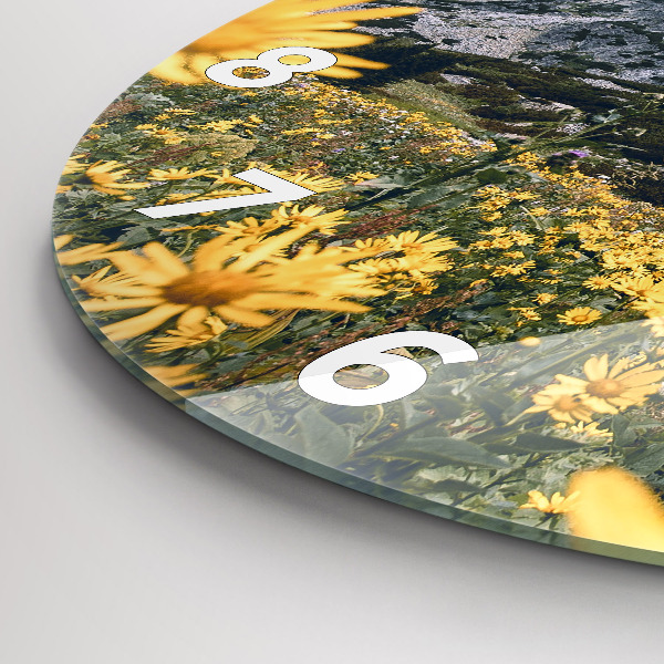 Round glass wall clock Meadow flowers in the mountains
