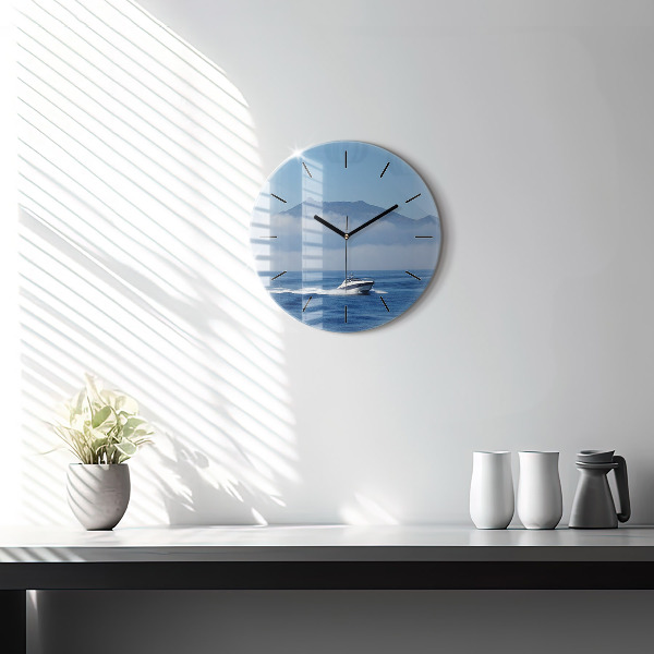 Round glass wall clock A boat floating on the ocean
