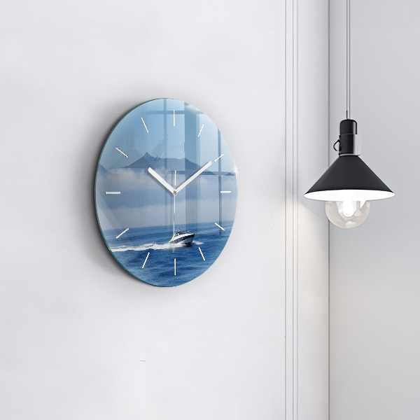 Round glass wall clock A boat floating on the ocean