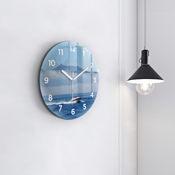 Round glass wall clock A boat floating on the ocean