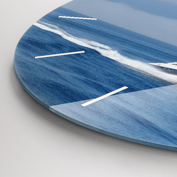 Round glass wall clock A boat floating on the ocean
