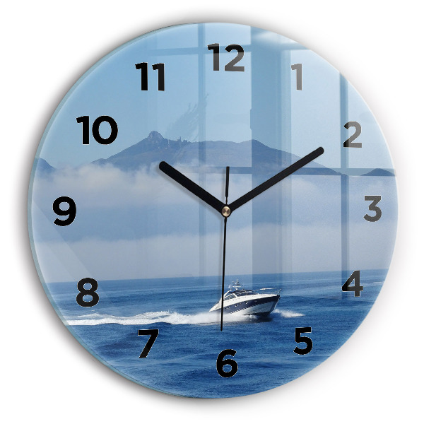 Round glass wall clock A boat floating on the ocean