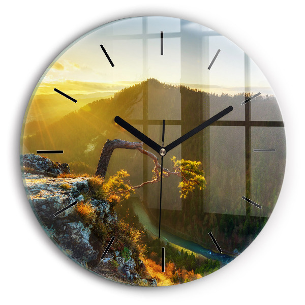 Round glass wall clock Sunset over the mountains