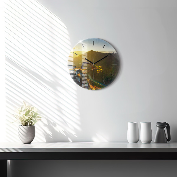 Round glass wall clock Sunset over the mountains