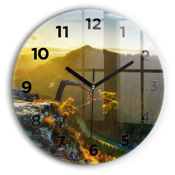 Round glass wall clock Sunset over the mountains