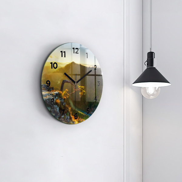 Round glass wall clock Sunset over the mountains