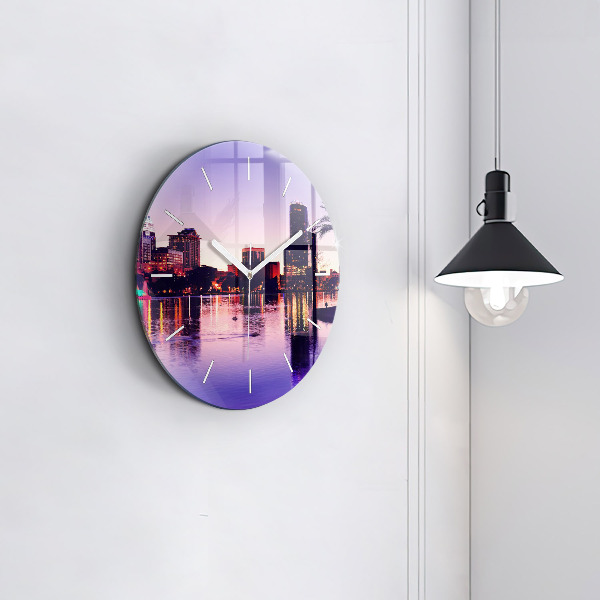 Round glass wall clock Evening panorama of the city